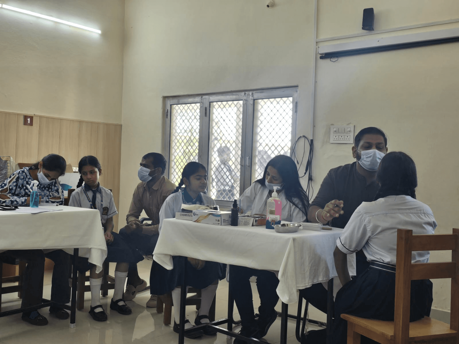 Doctor interacting with students & teachers
